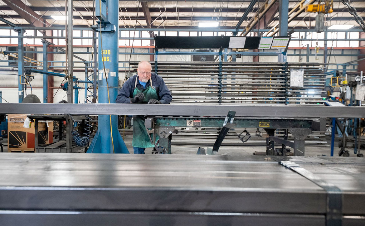 Man assembling an aluminum boat frame at Marine Components.