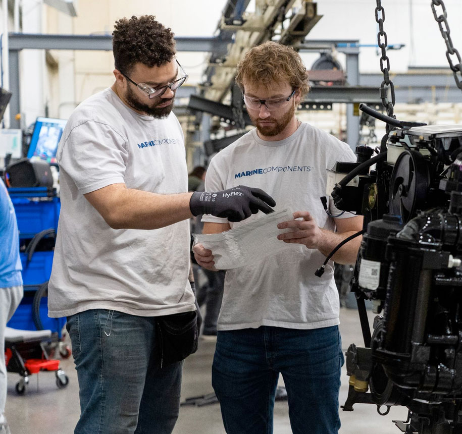 Marine Components employees reviewing papers.